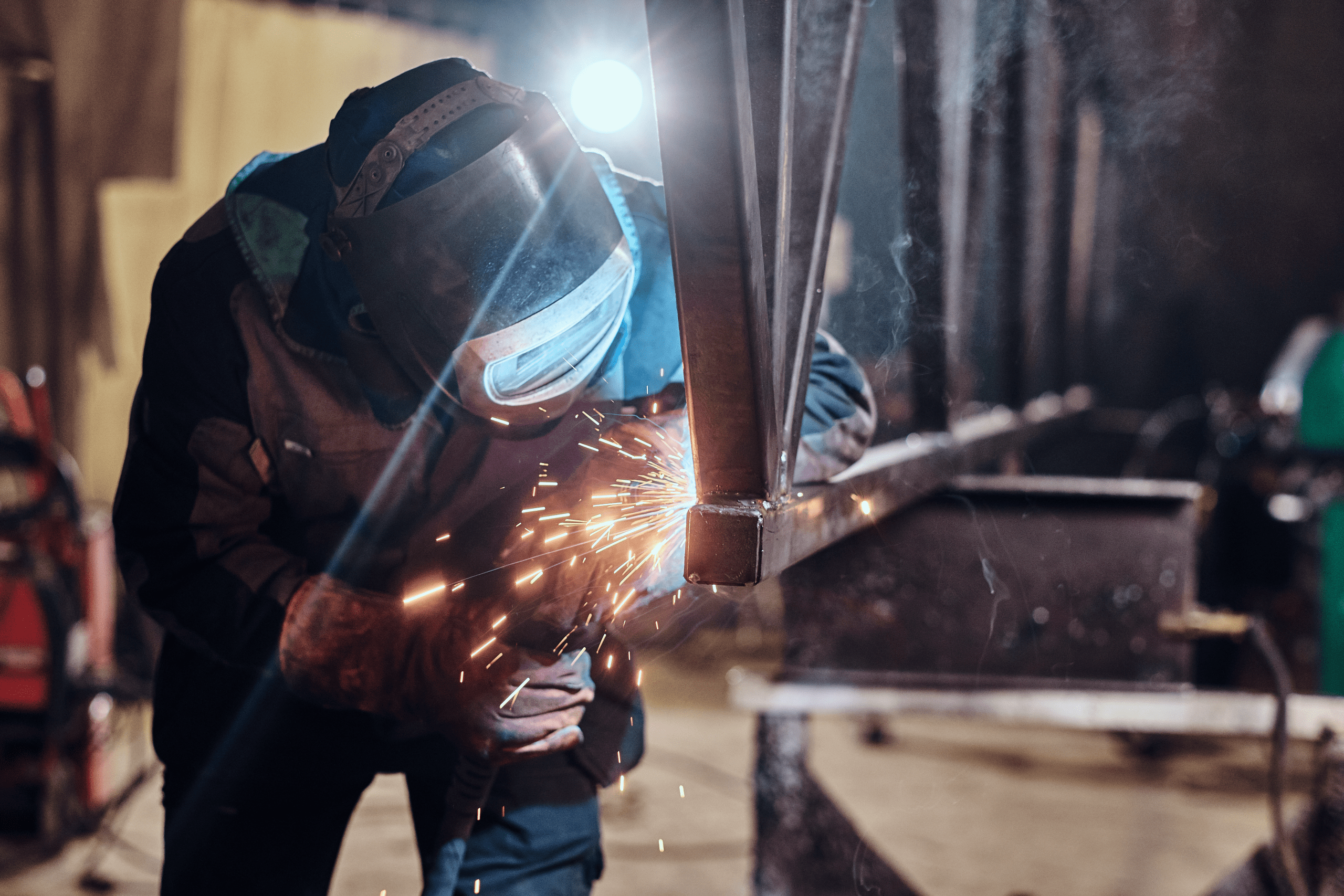 man-is-working-metal-factory-he-is-welding-piece-rail-using-special-tools shielded metal arc welding